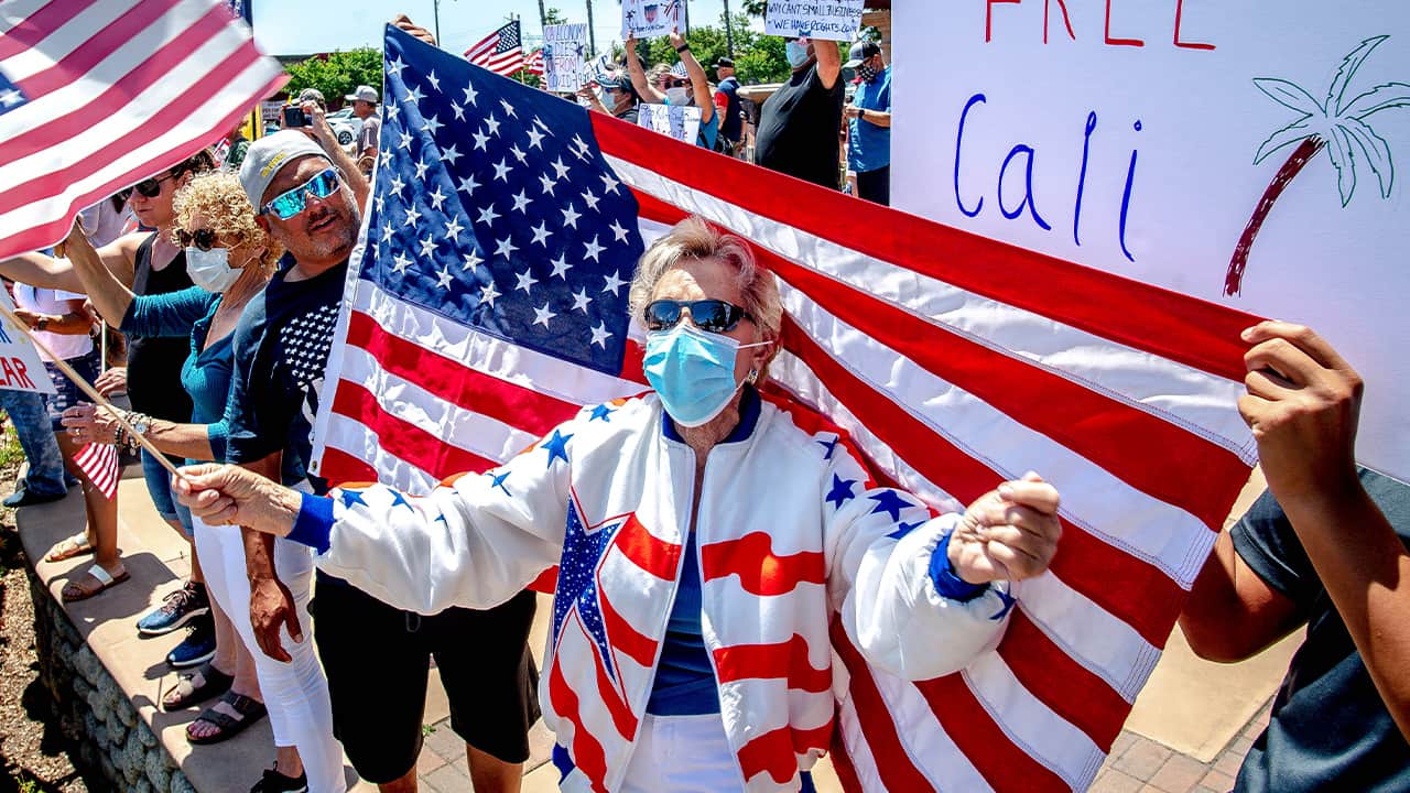 Photo of a woman wearing a mask during a rally 