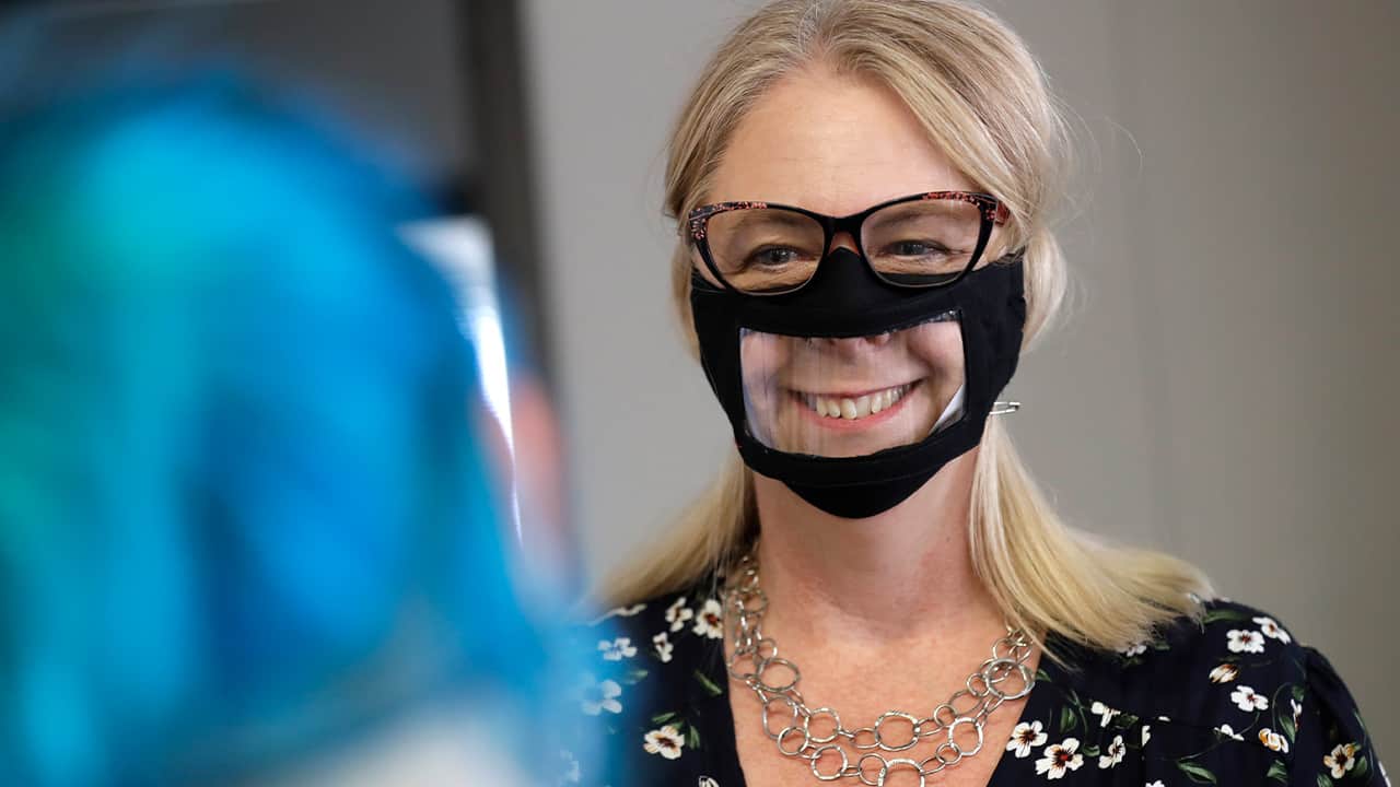 Photo fo a woman wearing a face mask with a window