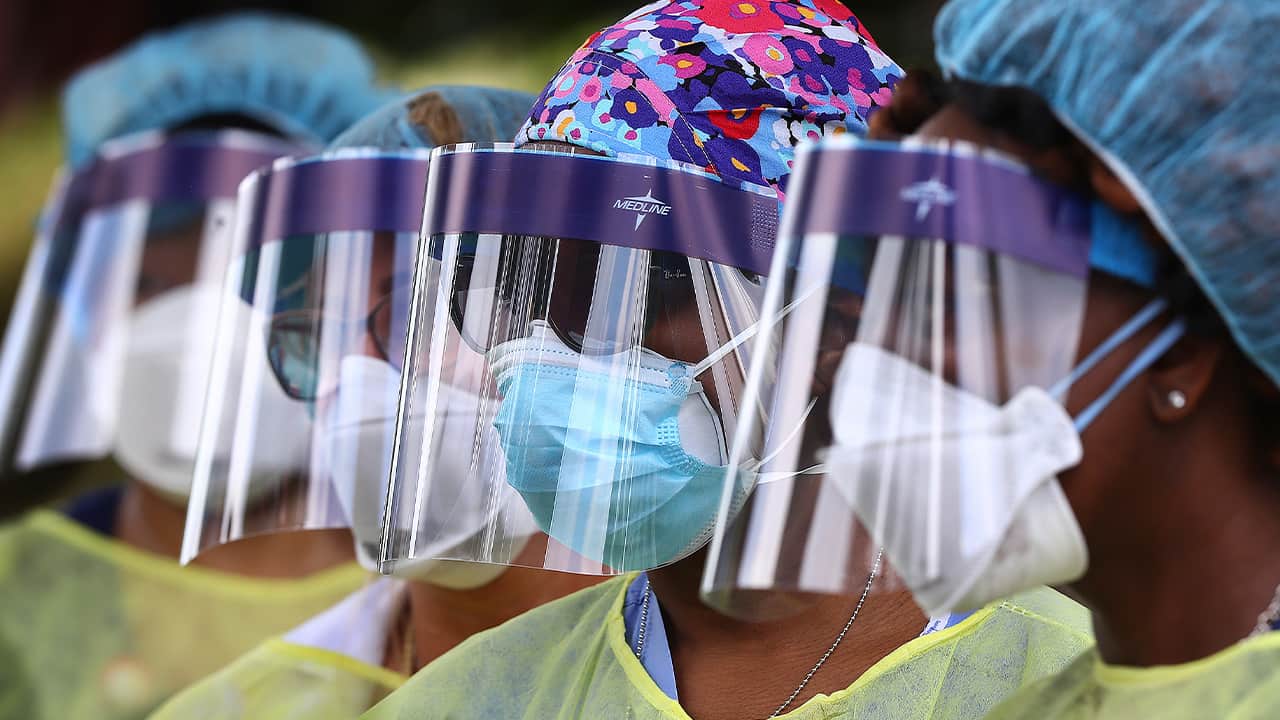 Photo of volunteers wearing face shields
