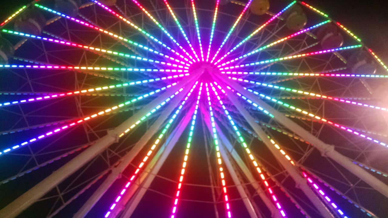 Photo of a ferris wheel at night