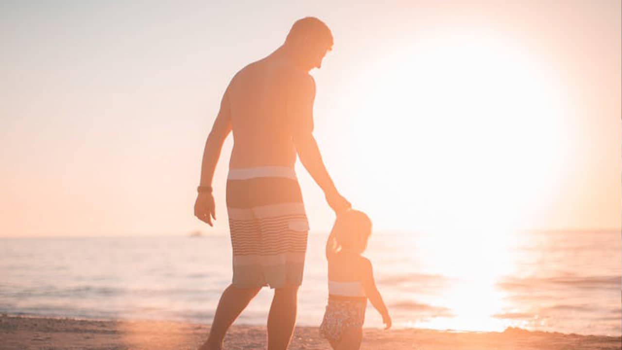 Photo of father and sun on the beach