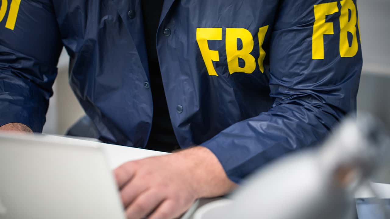 Image of an FBI agent working on a laptop