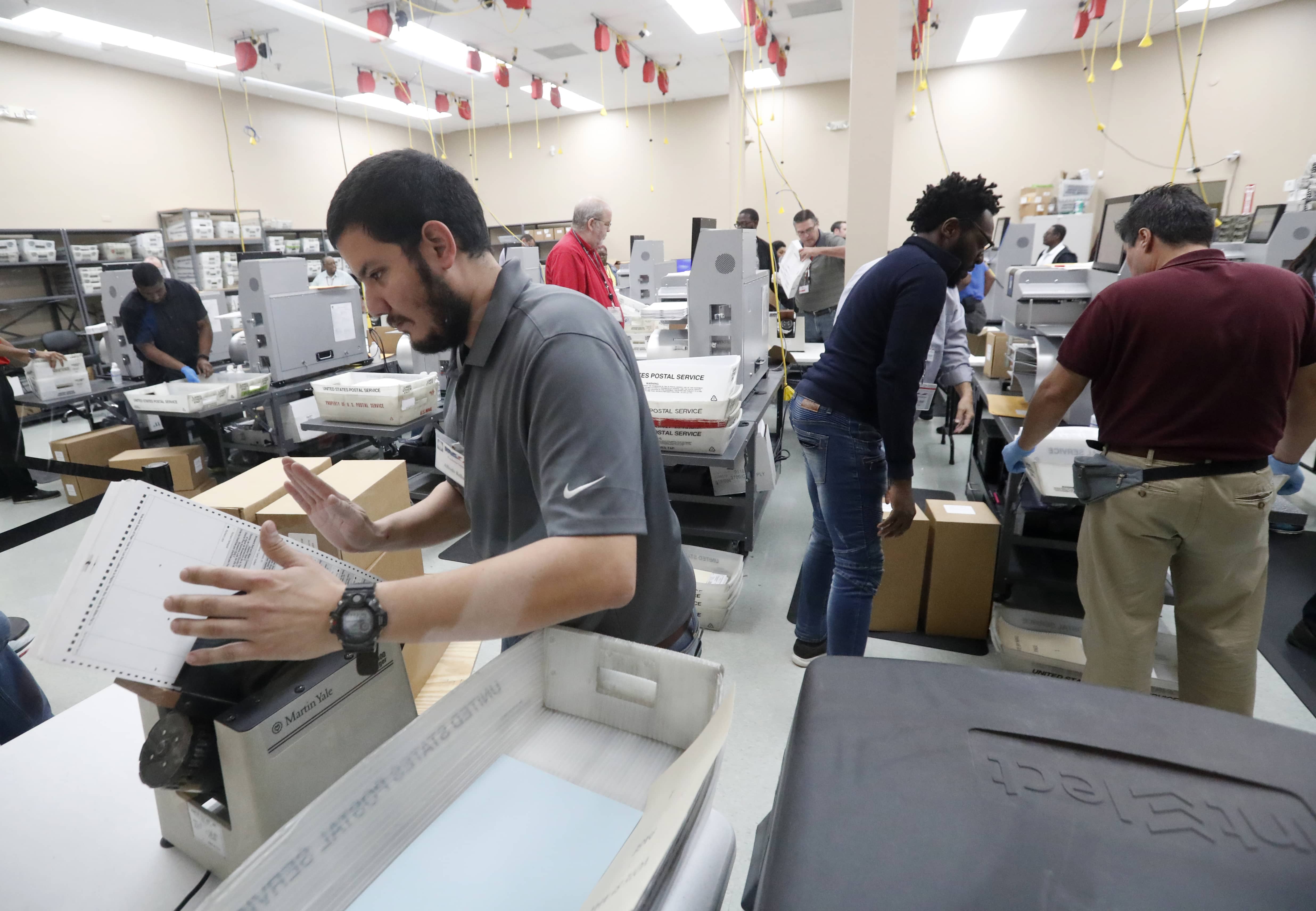 Photo of employees at the Broward County Supervisor of Elections office 