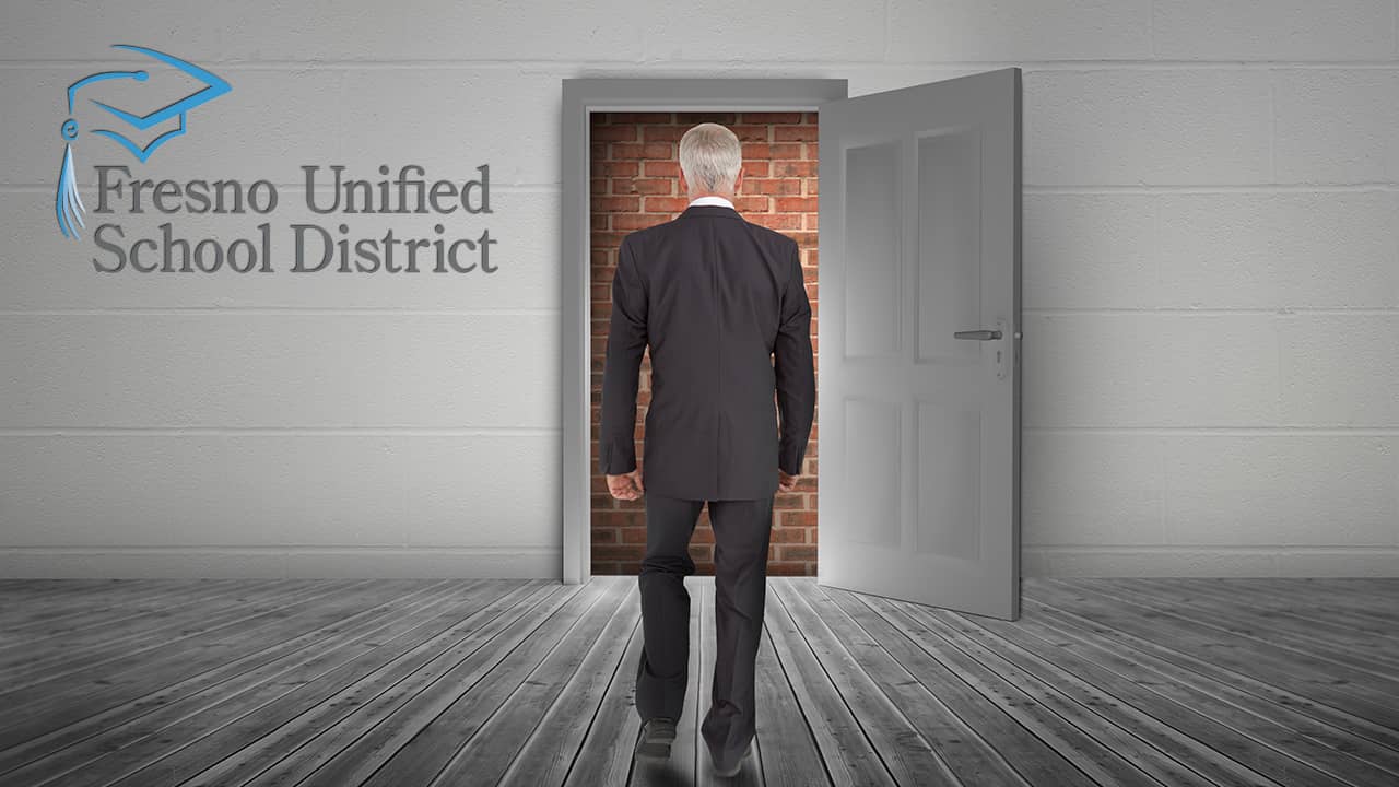 Photo of man facing a brick wall