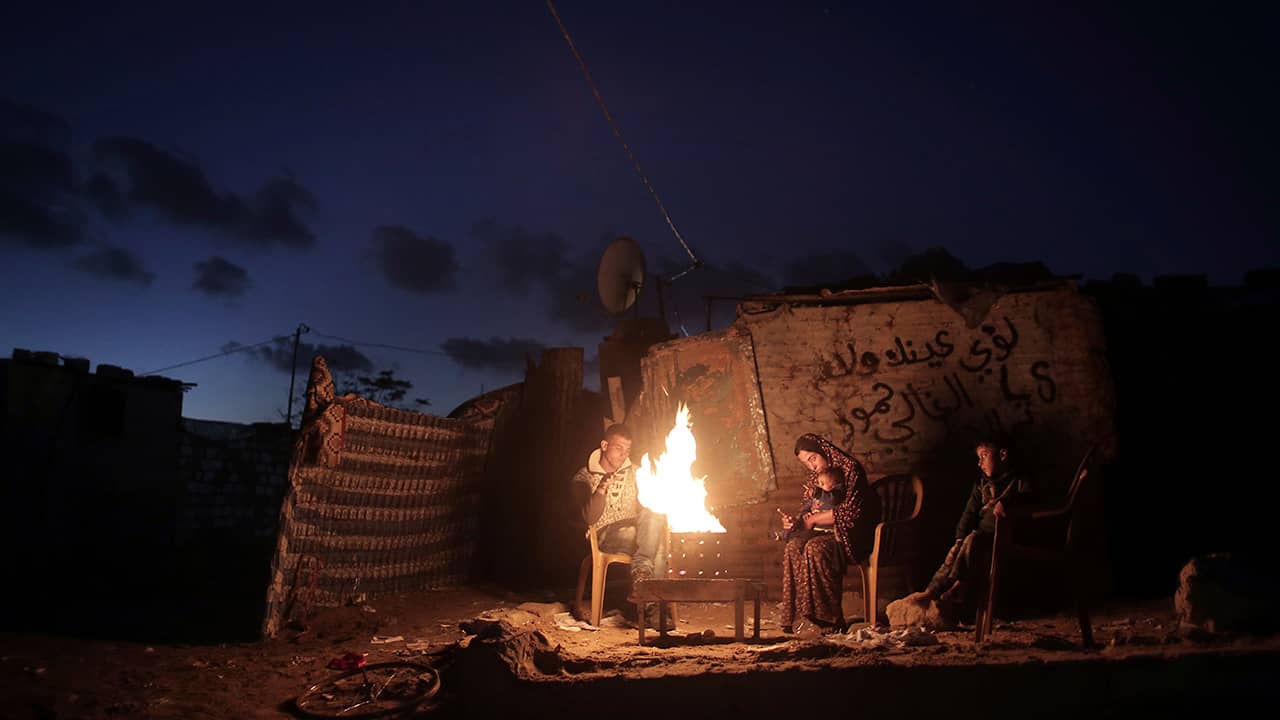 Photo of a Palestinian family outside of their makeshift house