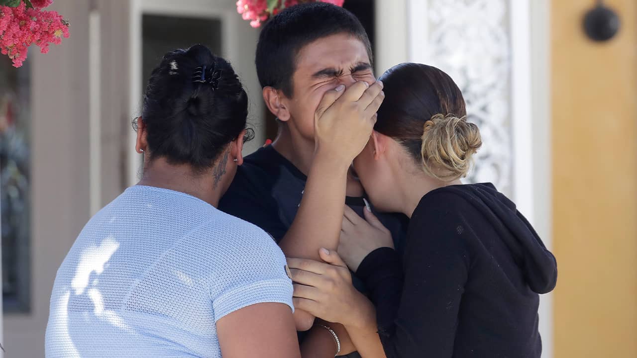 Photo of Joshua Guicho, 16, center, crying between his aunts Josephine Guicho, left, and Erica Guicho