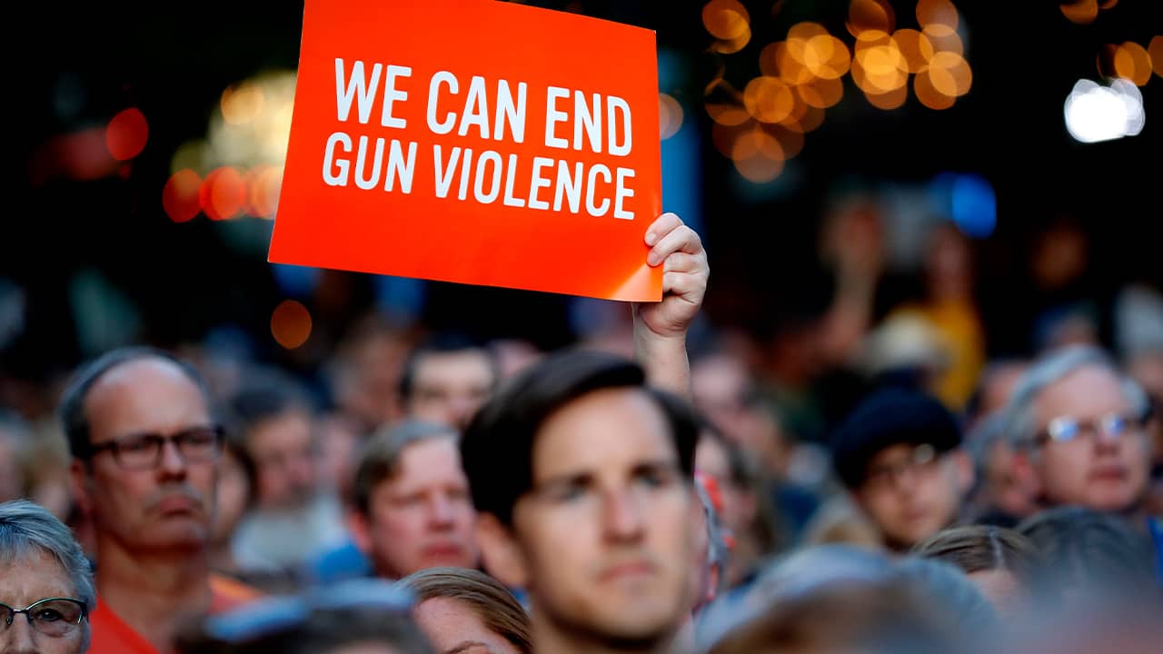 Photo of people attending a vigil for mass killing victims in Dayton, Ohioon