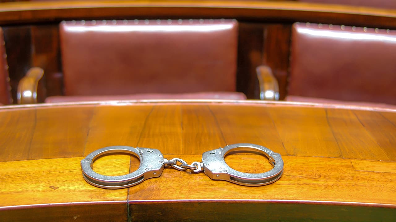 Photo of handcuffs on a court bench