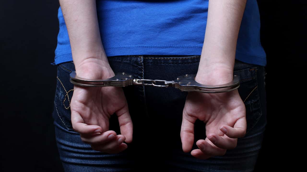Photo of a student in handcuffs