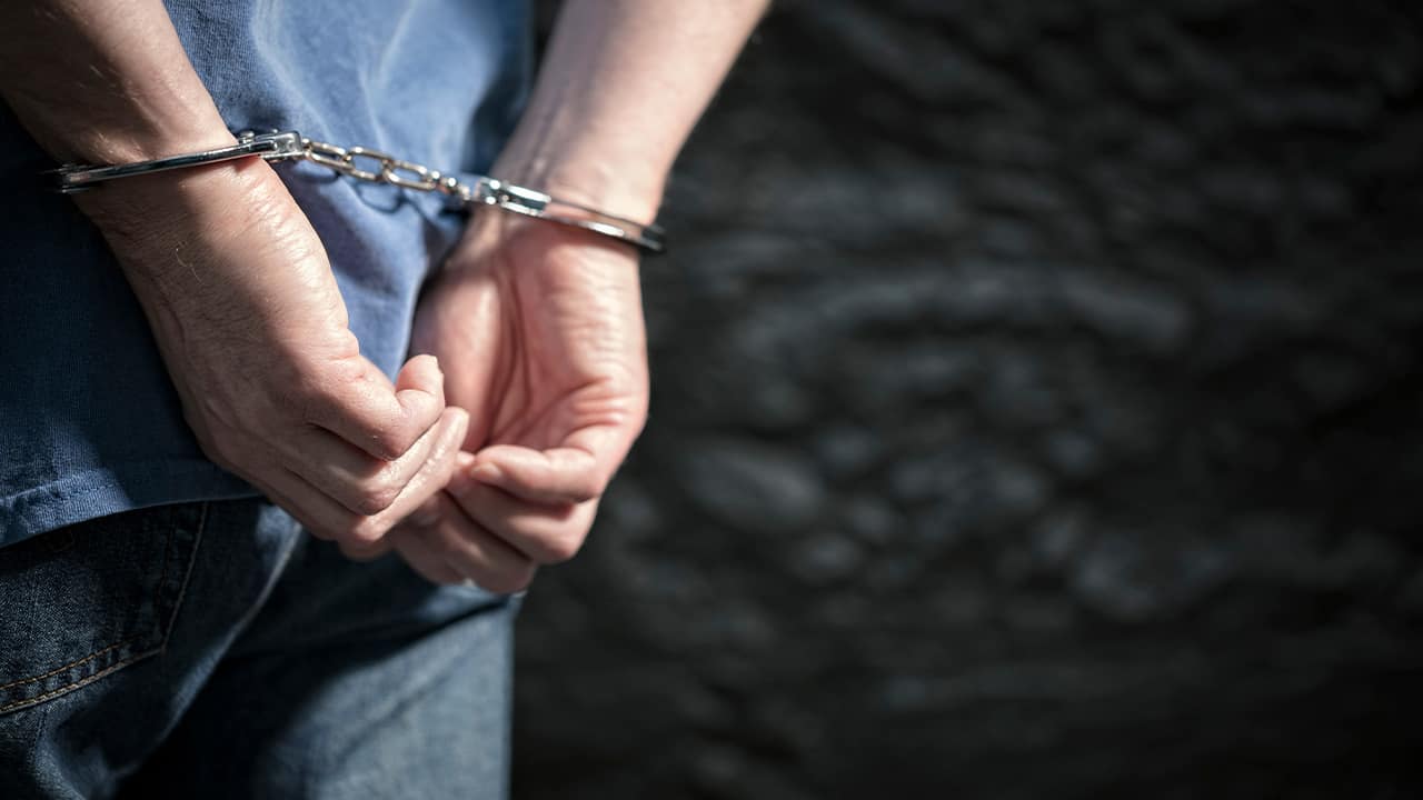 Photo of a arrested man in handcuffs