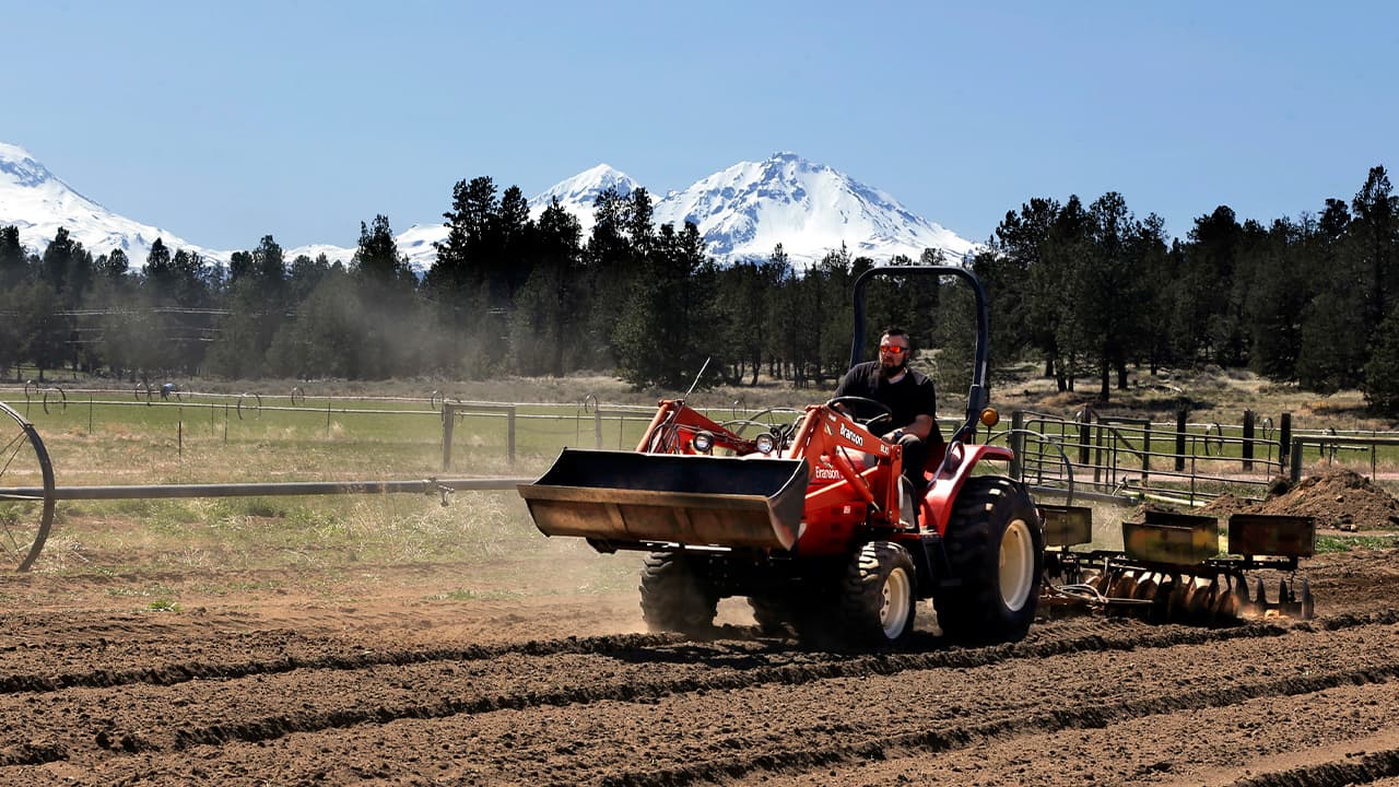 Photo of a plant manager readying a field for hemp crops 