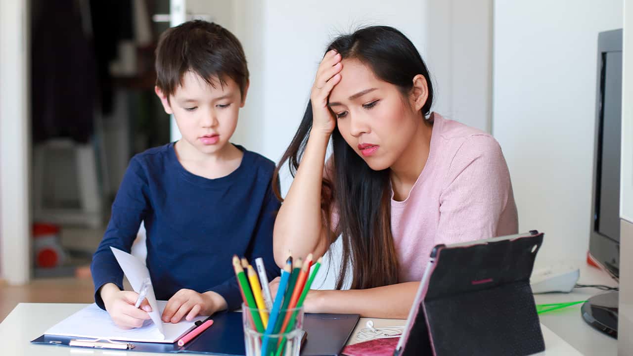 Image of a parent and child frustrated by distance online learning