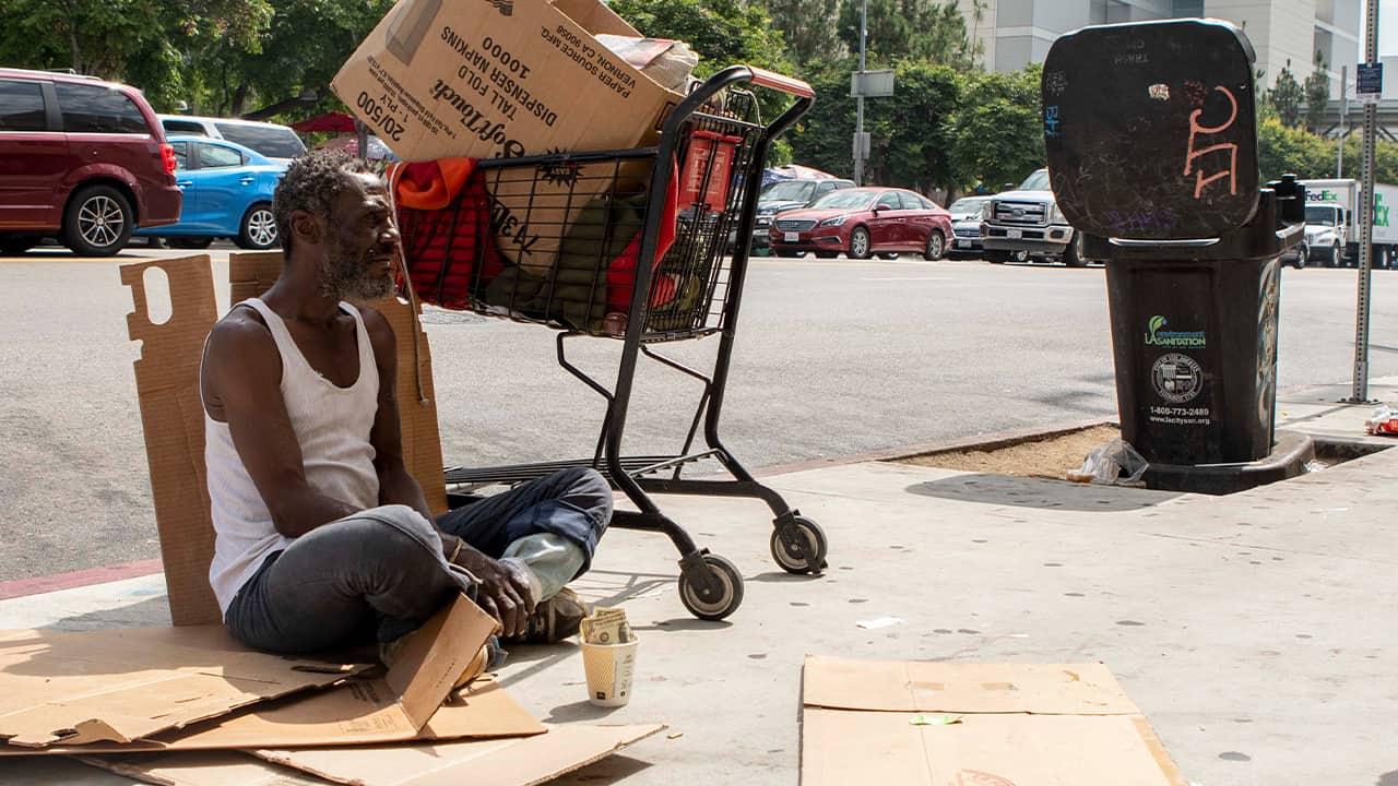 Photo of Will panhandling on the sidewalk