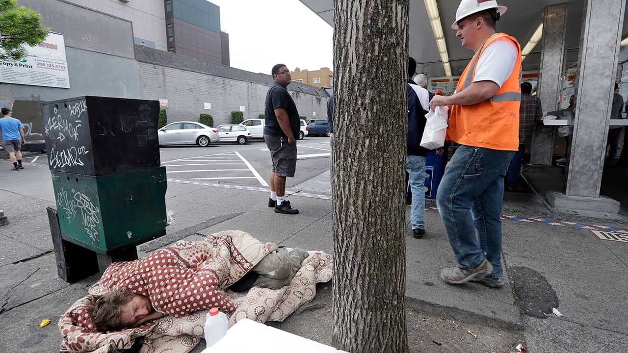 Photo of a man sleeping on the sidewalk in Seattle, WA