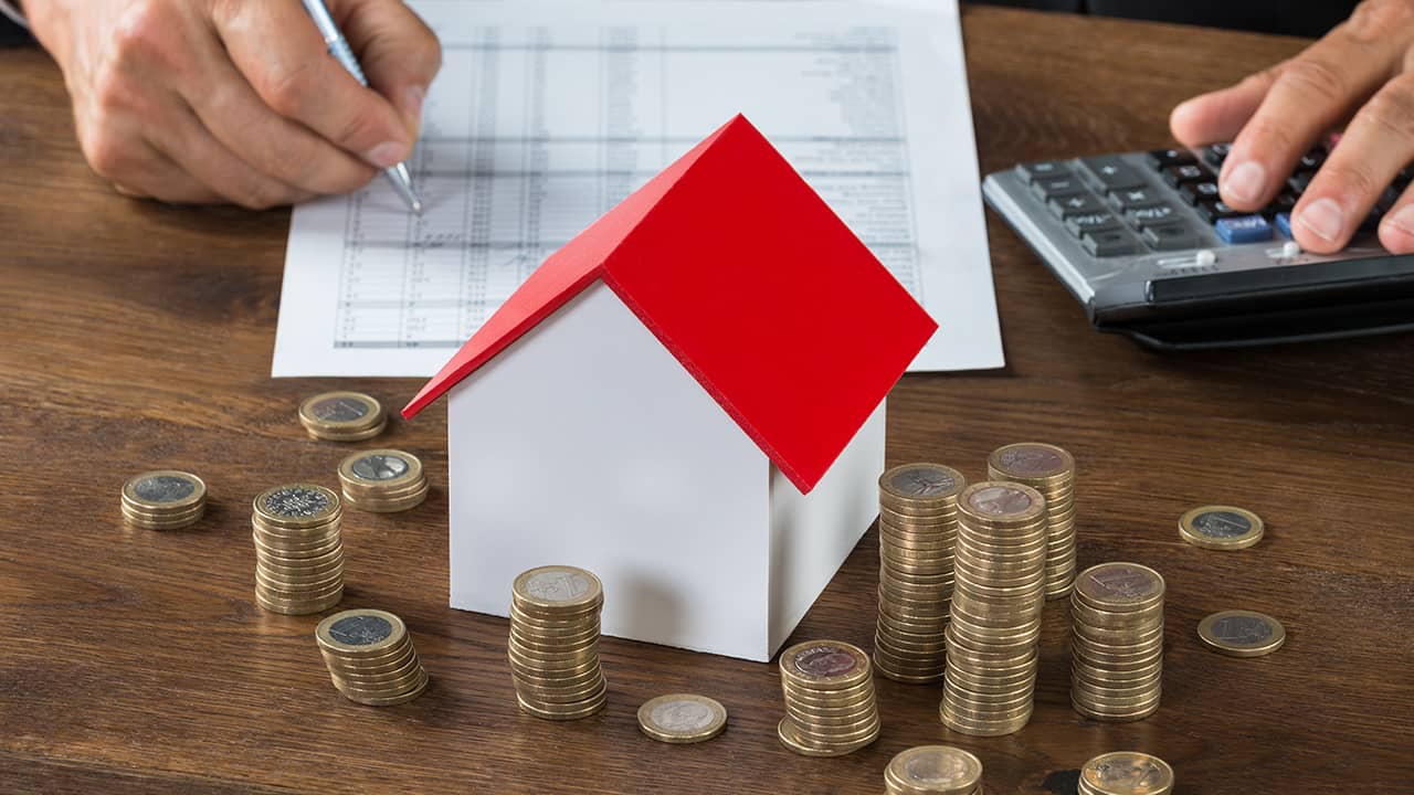 Photo of money and a tiny house