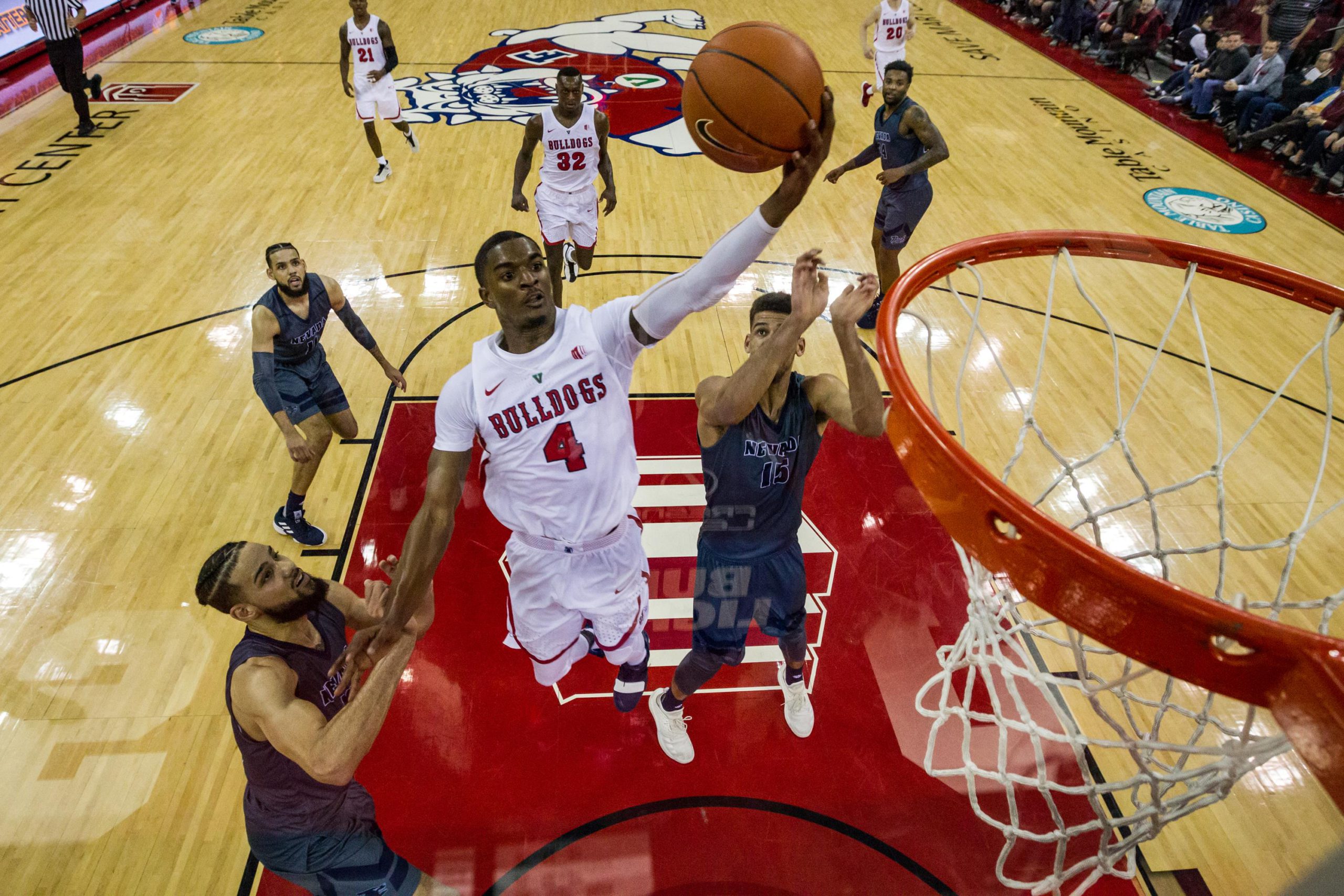 Photo of Braxton Huggins driving for a layup vs. Nevada