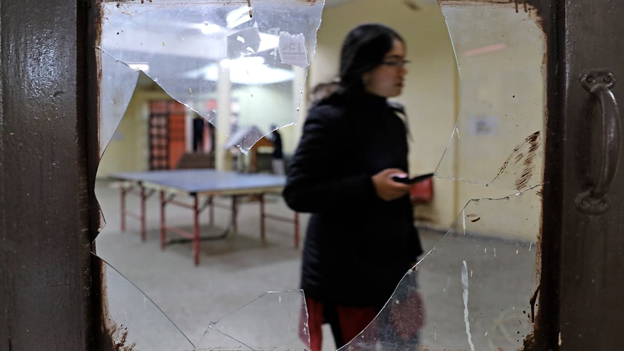 Photo of a student seen through broken glass