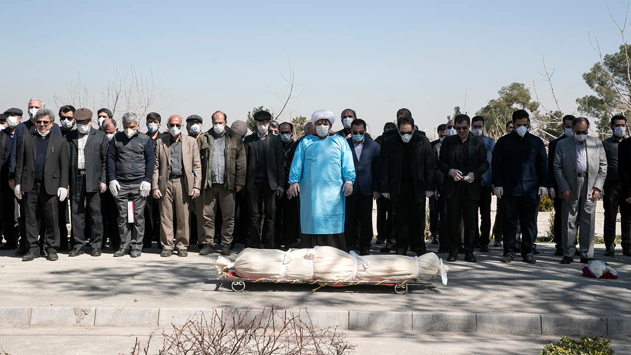 Photo of mourners praying over the body of former politburo official in the Revolutionary Guard Farzad Tazari