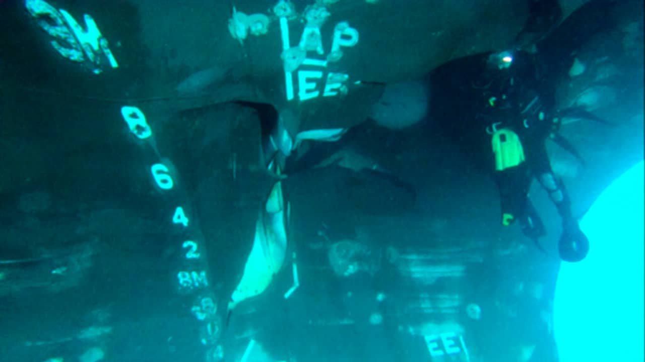 Photo of a diver investigating the damage done to the Saudi-owned oil tanker