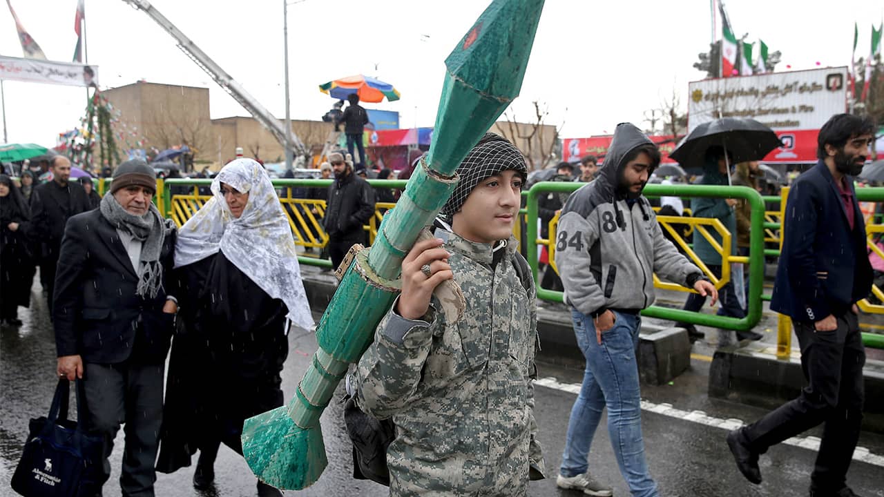 Photo of teenager carrying a mock rocket propelled grenade