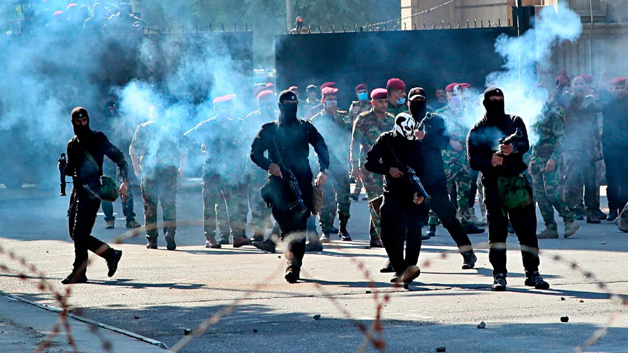 Photo of Iraqi security forces firing tear gas