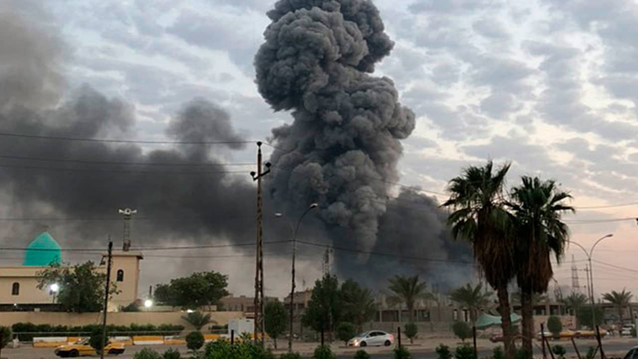 Photo of plumes of smoke rising at a military base in Baghdad, Iraq