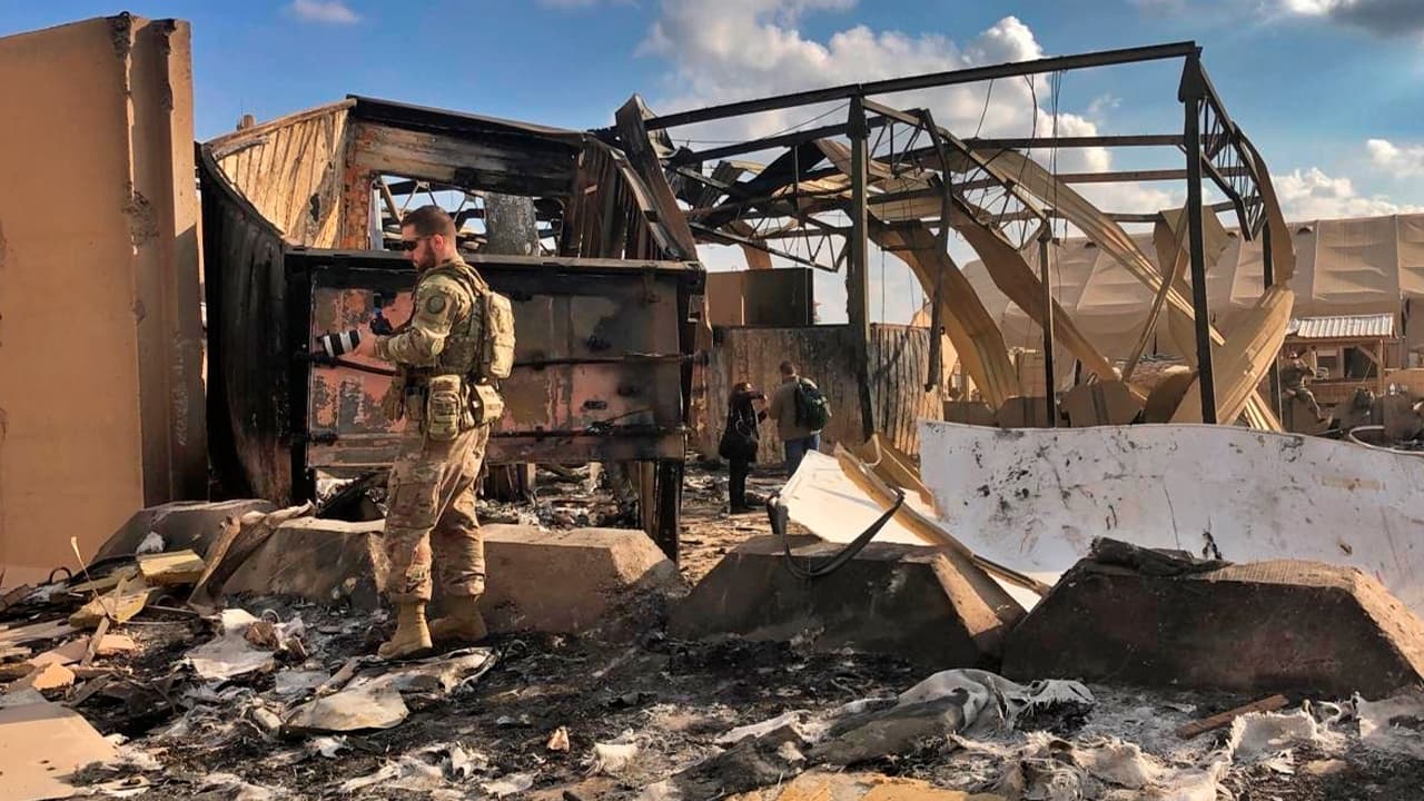 Photo of U.S. soldiers and journalists inspecting the rubble