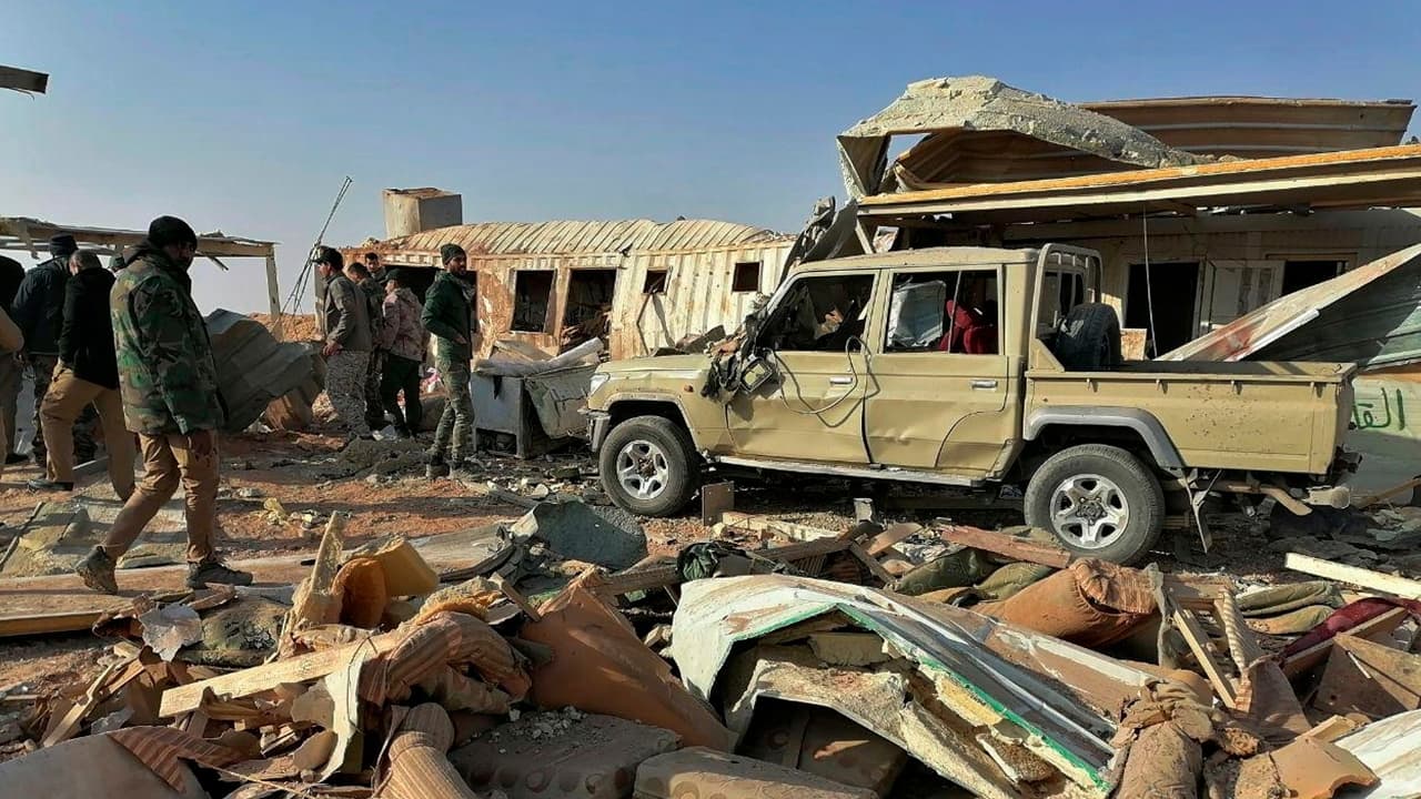 Photo of fighters from the Kataeb Hezbollah, or Hezbollah Brigades militia inspecting destruction
