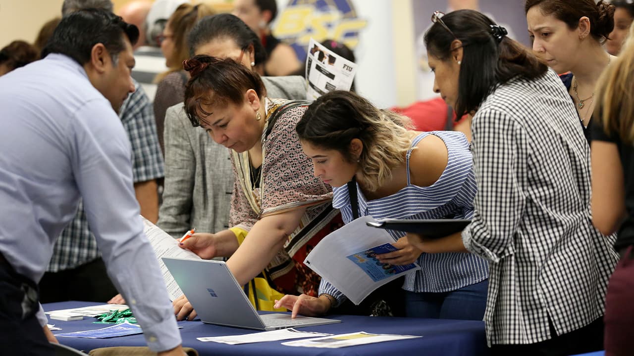 Photo of applicants looking at available jobs