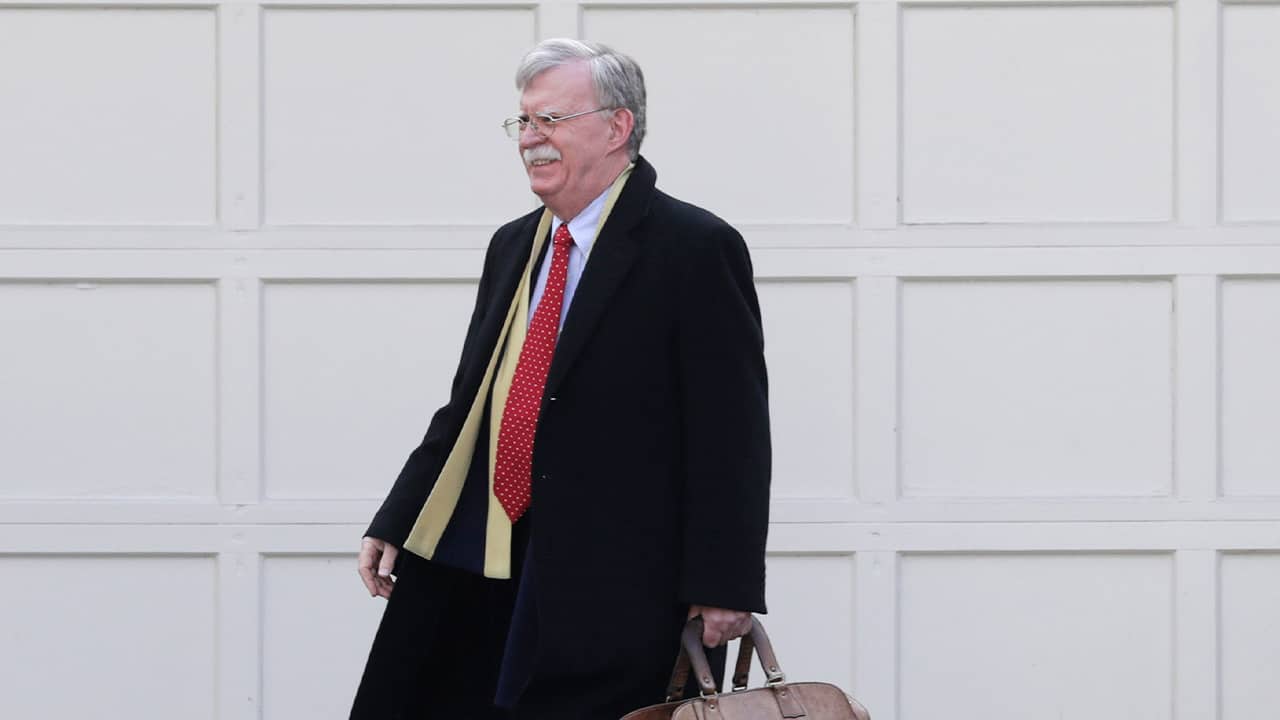Photo of John Bolton leaving his house