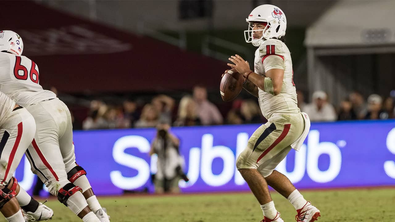 Photo of Fresno State quarterback Jorge Rena eyeing a receiver downfield against USC