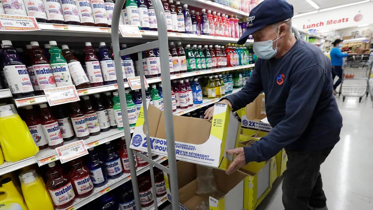 Photo of Juan Santos stocking shelves