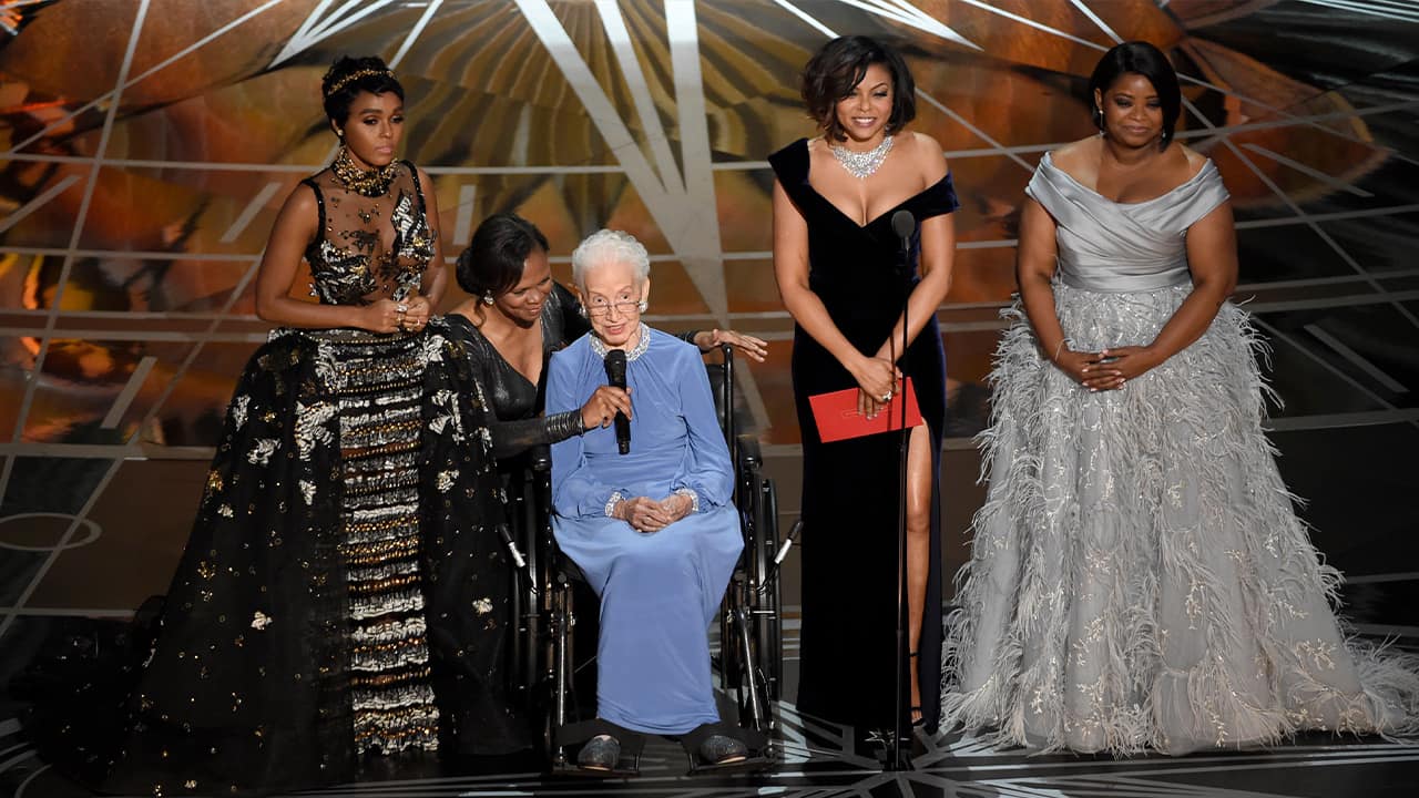 Photo of Janelle Monae, left, Taraji P. Henson, second right and Octavia Spencer, right, introduce Katherine Johnson, seated, the inspiration for "Hidden Figures," as they present the award for best documentary feature at the Oscars