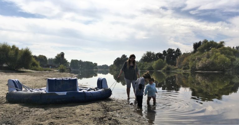 Photo of a mother and her children wading in the Kings River