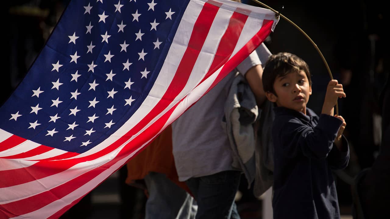 Photo of a young boy holding an American flag