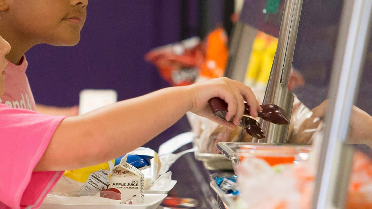 Photo of a girl getting lunch in a cafeteria