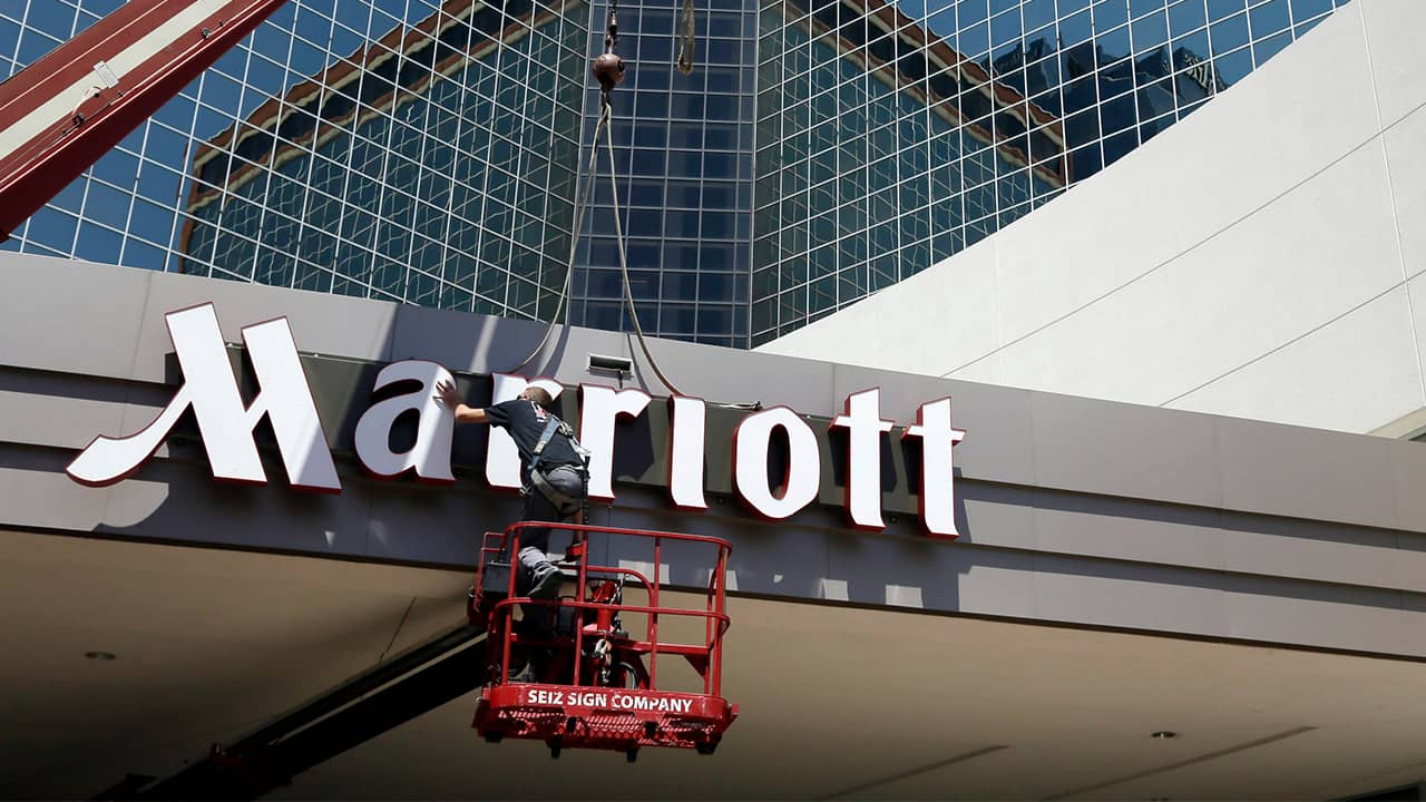 Photo of man working on a Marriott hotel sign