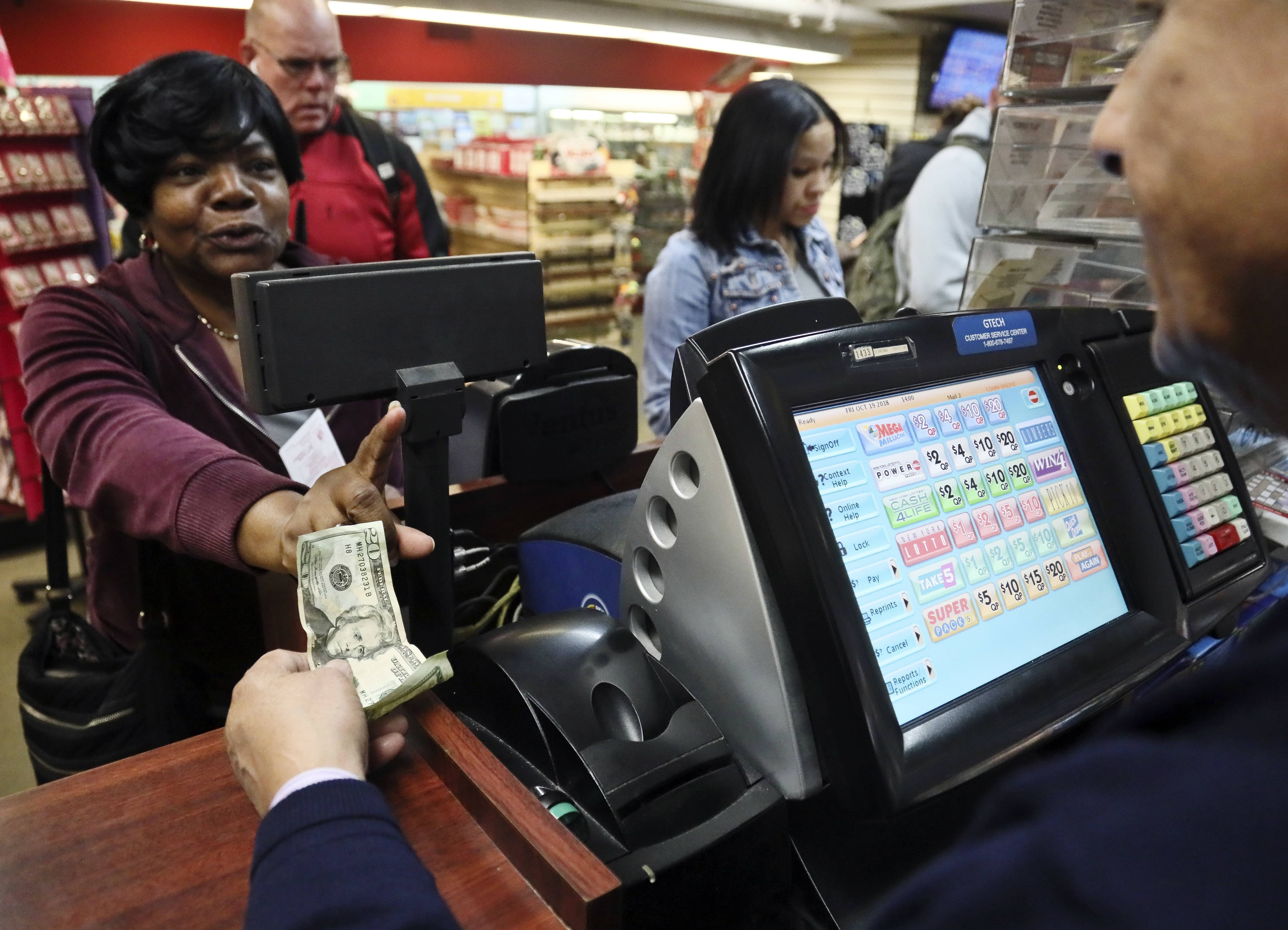 Photo of woman buying a Mega Millions lottery ticket in New York