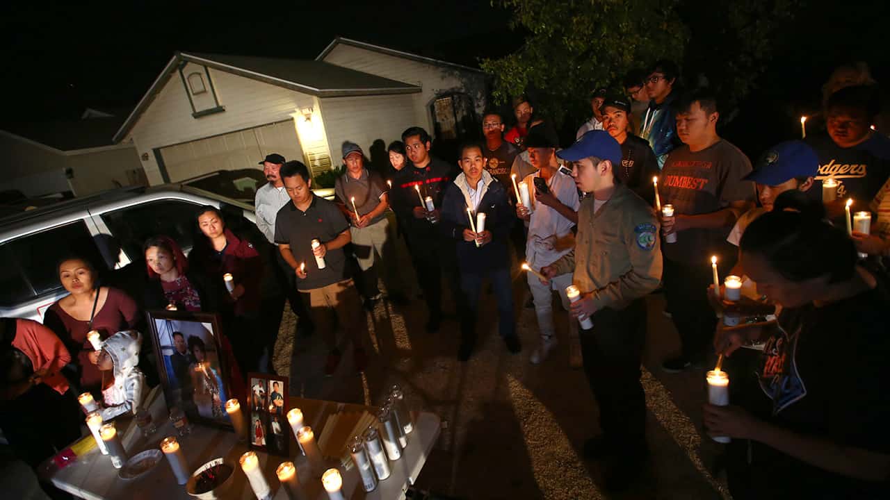 Photo of friends and family of shooting victim Kou Xiong during a candle light vigil in Fresno