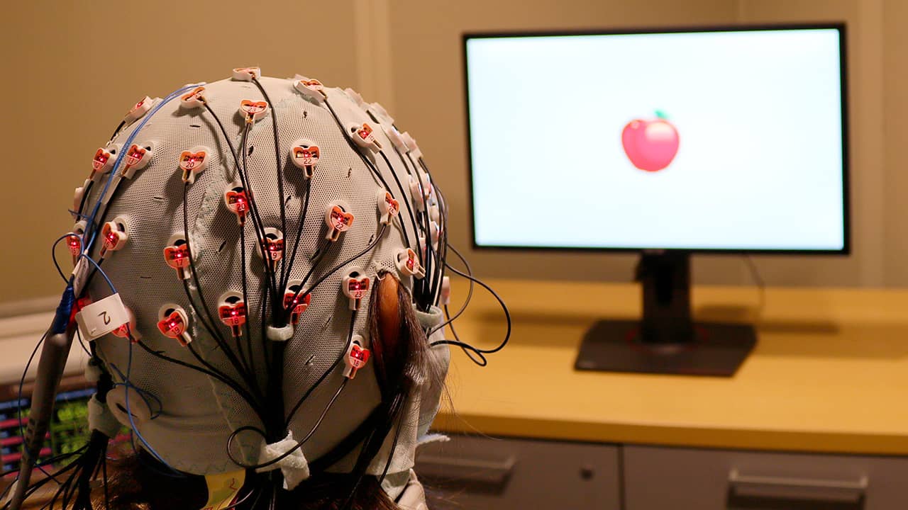 Pjhoto of a cap that administers electrical stimulation and monitors brainwaves