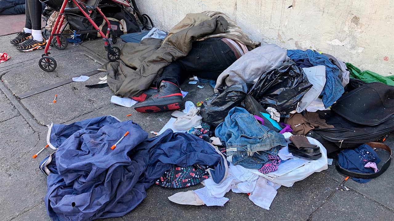 Photo of sleeping people and used needles on the ground in San Francisco