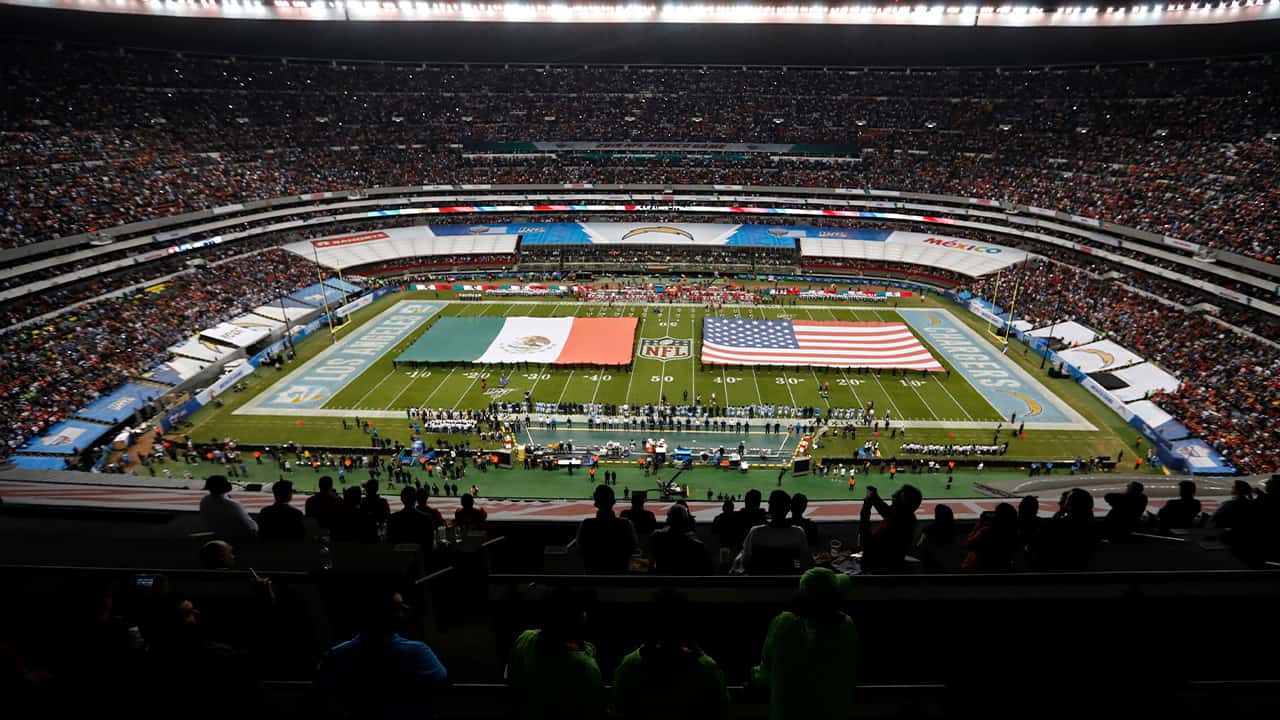 Photo of Mexico and US flag covering the field during an NFL game 