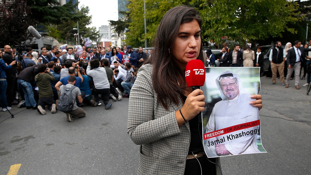 Photo of journalist holding a poster of missing Saudi writer Jamal Khashoggi