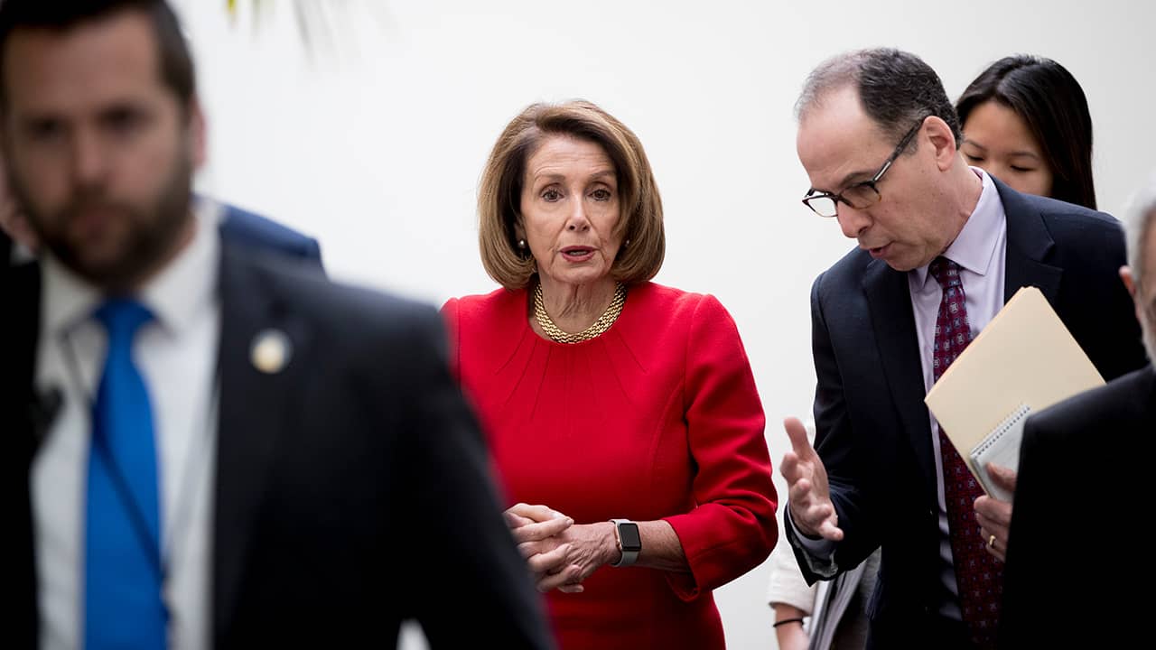 Photo of Nancy Pelosi leaving House Democratic caucus meeting
