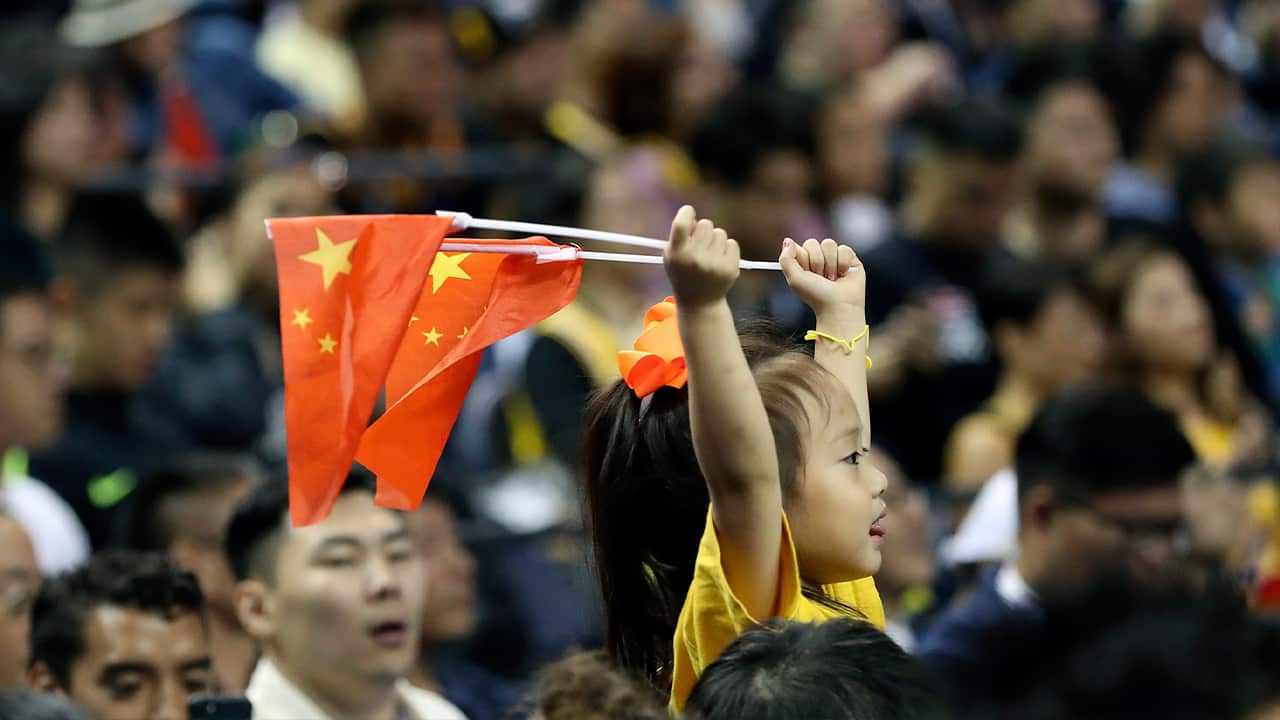 Photo of a child holding Chinese national flags