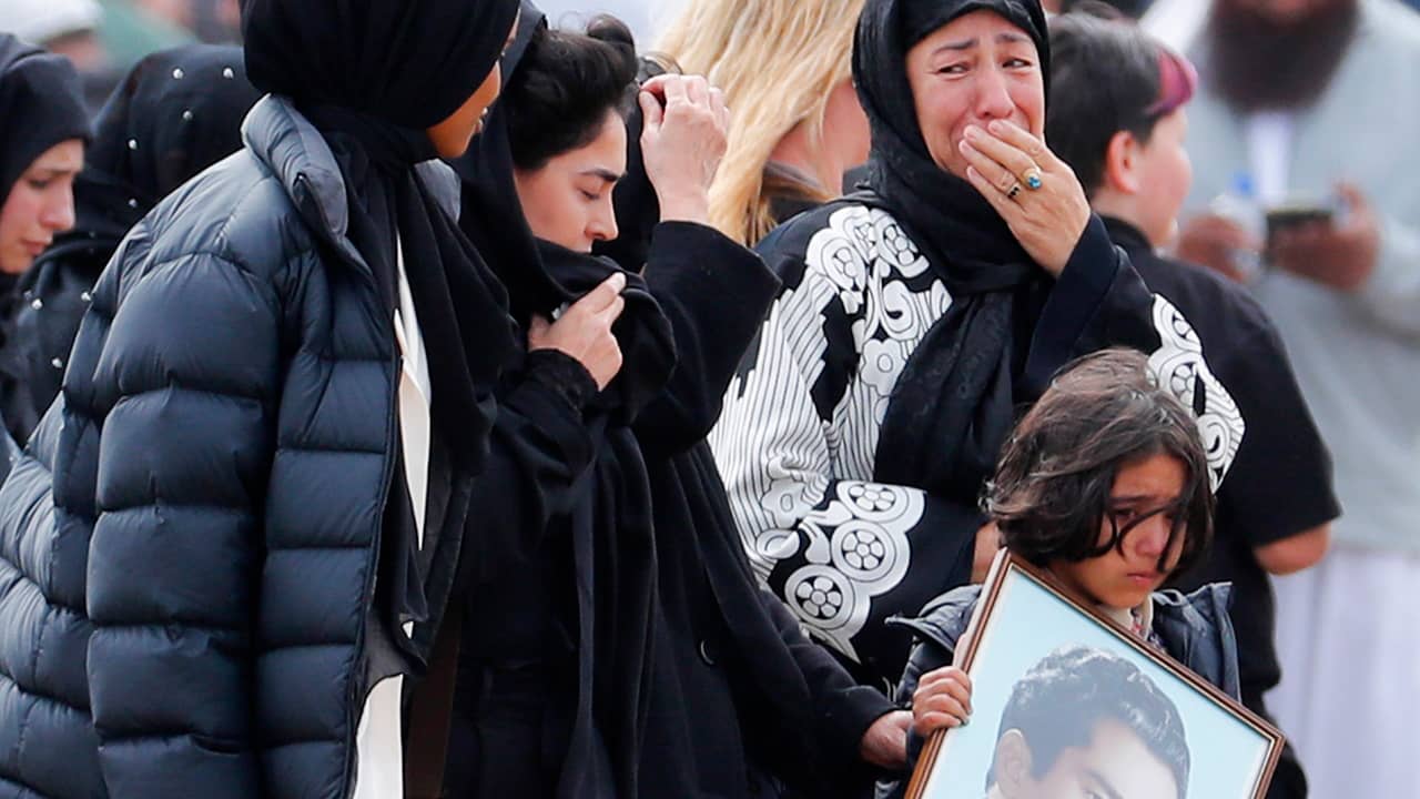 Photo of mourners arriving at a burial service