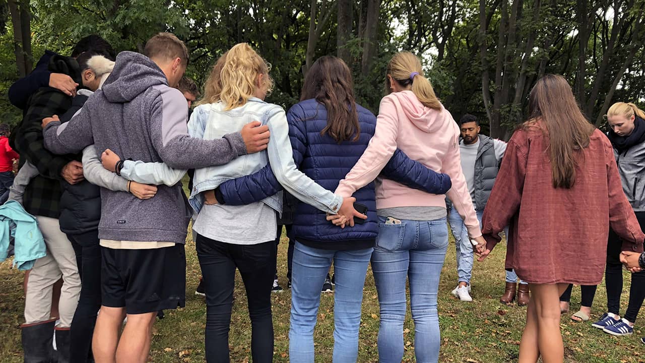 Photo of a group of people praying in New Zealand