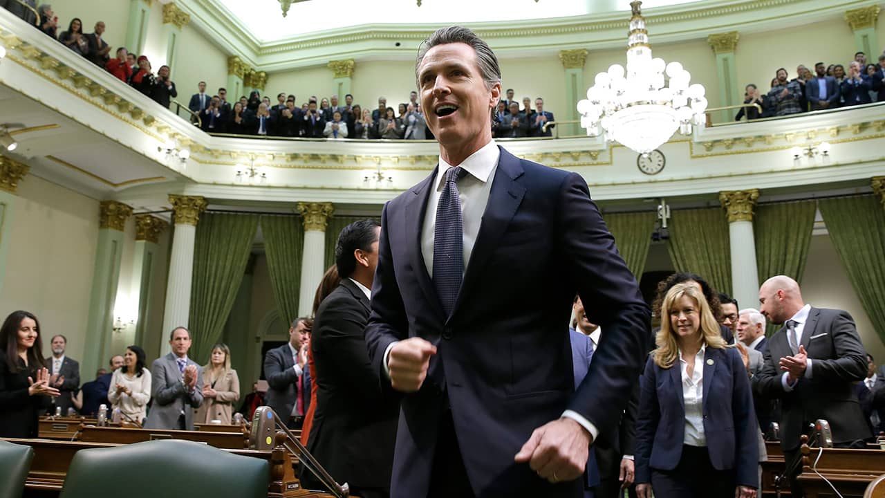 Gov. Gavin Newsom enters the Capitol chamber
