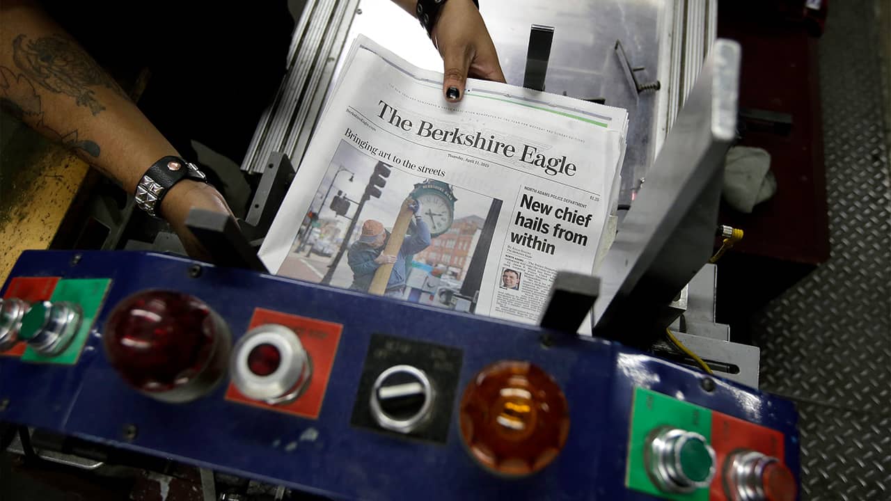 Photo of The Berkshire Eagle newspapers being placed in a machine