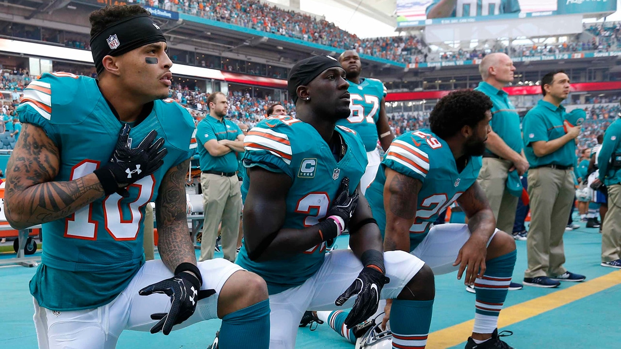 Photo of Miami Dolphins kneeling during the National Anthem before NFL game